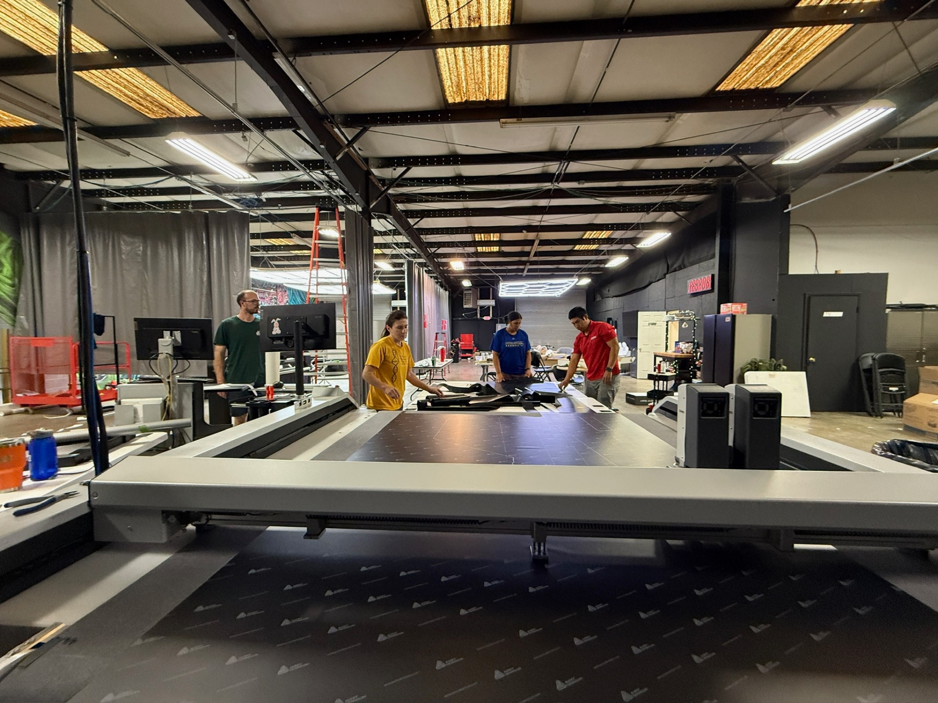Cutting cardboard inserts in-house on the flatbed — the same panels that ship with every kit.